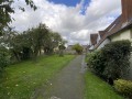 Fronting an area of green and church yard
